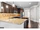 Large kitchen features a center island, granite countertops, stainless steel appliances, and dark cabinetry at 162 Aylesbury Blvd, Mcdonough, GA 30252