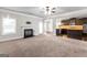 Open-concept living room view featuring fireplace, kitchen, and dining areas at 162 Aylesbury Blvd, Mcdonough, GA 30252