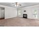 Spacious living room with fireplace, ceiling fan, and outdoor access at 162 Aylesbury Blvd, Mcdonough, GA 30252