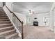 Open-concept living room with fireplace, staircase, and access to the outdoor space at 162 Aylesbury Blvd, Mcdonough, GA 30252