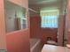 Charming bathroom with vintage pink tile and a tub shower at 18 North Ave, Hampton, GA 30228