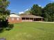 Charming single-story brick home with a covered front porch and a well-maintained lawn at 18 North Ave, Hampton, GA 30228