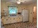 Traditional kitchen with ample counter space, white appliances, and cozy window with lots of light at 18 North Ave, Hampton, GA 30228