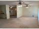 Spacious living area featuring multiple ceiling fans and views into an adjacent kitchen at 18 North Ave, Hampton, GA 30228