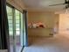 Open floor plan living area with bar and bright windows to sunroom at 18 North Ave, Hampton, GA 30228