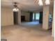 Open-concept living room with fireplace, carpeted flooring, and seamless flow into kitchen and outdoor spaces at 18 North Ave, Hampton, GA 30228