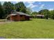 Spacious backyard featuring an outbuilding and plenty of room for outdoor activities or potential additions at 18 North Ave, Hampton, GA 30228