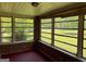 Enclosed sunroom featuring brick walls and many large windows, filling the space with natural light at 18 North Ave, Hampton, GA 30228