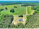 Panoramic aerial view showcases the home's expansive property surrounded by lush greenery and wooded areas at 1621 Dixie Rd, Covington, GA 30014