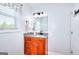 Bathroom with granite countertop, wood cabinets, and modern fixtures at 1621 Dixie Rd, Covington, GA 30014