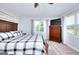 Bright bedroom featuring a wooden bed frame, mounted TV, and neutral tones at 1621 Dixie Rd, Covington, GA 30014