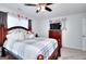 Spacious bedroom with bed, mounted TV, and a mix of neutral colors at 1621 Dixie Rd, Covington, GA 30014