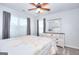 Bright bedroom featuring a bed, dresser, and multiple windows for natural light at 1621 Dixie Rd, Covington, GA 30014