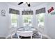 Cozy breakfast nook featuring a round table, natural light, and charming decor at 1621 Dixie Rd, Covington, GA 30014