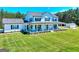 Beautiful two-story home with white siding, black shutters, large front porch, and sprawling green lawn at 1621 Dixie Rd, Covington, GA 30014