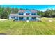 Inviting two-story home with a large front porch and expansive lawn and a swing in the yard at 1621 Dixie Rd, Covington, GA 30014