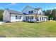 Charming two-story home with a large front porch, white siding, and well-maintained landscaping at 1621 Dixie Rd, Covington, GA 30014