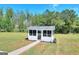 Scenic exterior view of a charming home, surrounded by lush greenery and serene landscape at 1621 Dixie Rd, Covington, GA 30014