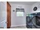 Modern laundry room featuring new washer and dryer units, and ample storage space at 1621 Dixie Rd, Covington, GA 30014