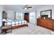 Bright and airy main bedroom featuring neutral tones, carpeted floors and natural light from large windows at 1621 Dixie Rd, Covington, GA 30014