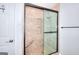 Walk-in shower featuring a built-in bench, tiled walls, and a modern sliding glass door at 1621 Dixie Rd, Covington, GA 30014