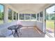 Bright and airy sun room with multiple windows offering panoramic views of the surrounding nature at 1621 Dixie Rd, Covington, GA 30014