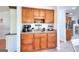 A stylish wet bar area with wood cabinets, granite countertops, and stainless steel sink at 1621 Dixie Rd, Covington, GA 30014