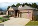 Charming single-Gathering home with a brick exterior, well-manicured lawn, and a two-car garage at 511 Bonneset Ct, Canton, GA 30114