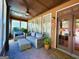 Inviting sunroom featuring comfortable seating, brick flooring, and ample natural light at 511 Bonneset Ct, Canton, GA 30114