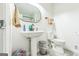 Clean bathroom with a pedestal sink, toilet, and tiled floor at 870 The Cir, Lawrenceville, GA 30043