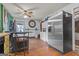 View of kitchen with stainless appliances and wooden laminate flooring plus a bar top with seating at 870 The Cir, Lawrenceville, GA 30043