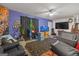 Spacious living room with an accent wall, a ceiling fan, a large television and unique decor at 870 The Cir, Lawrenceville, GA 30043