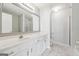 Bathroom featuring a large mirror, vanity, and a glass shower at 1363 Penhurst Dr, Lawrenceville, GA 30043