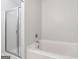 Bathroom featuring a glass-enclosed shower and tub at 1363 Penhurst Dr, Lawrenceville, GA 30043