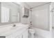Bathroom featuring a shower-tub combo and grey cabinet at 1363 Penhurst Dr, Lawrenceville, GA 30043