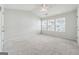 Vaulted-ceiling bedroom with neutral carpet, a ceiling fan, and natural light streaming through the windows at 1363 Penhurst Dr, Lawrenceville, GA 30043
