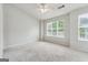Bedroom with neutral carpet, a ceiling fan, and natural light streaming through the window at 1363 Penhurst Dr, Lawrenceville, GA 30043
