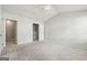 Vaulted-ceiling bedroom with neutral carpet, a ceiling fan, and view to hallway at 1363 Penhurst Dr, Lawrenceville, GA 30043