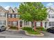 Charming townhome with brick accents, complemented by lush landscaping and a mature shade tree at 1363 Penhurst Dr, Lawrenceville, GA 30043
