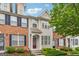 Attractive townhome showcases a classic brick facade, inviting entrance, and well-maintained landscaping at 1363 Penhurst Dr, Lawrenceville, GA 30043