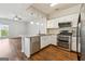 Contemporary kitchen featuring stainless steel appliances, granite countertops, and hardwood floors at 1363 Penhurst Dr, Lawrenceville, GA 30043