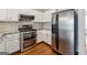 Modern kitchen with stainless steel appliances, granite counters, and white cabinetry at 1363 Penhurst Dr, Lawrenceville, GA 30043