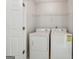 Laundry room featuring a white washer and dryer and wire shelving at 1363 Penhurst Dr, Lawrenceville, GA 30043