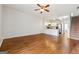 Inviting living room with hardwood floors, ceiling fan, open to the modern kitchen with stainless appliances at 1363 Penhurst Dr, Lawrenceville, GA 30043