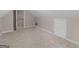 Spacious attic featuring neutral walls and carpet and two storage closets at 445 Royal St, Mcdonough, GA 30253