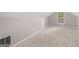 Bright attic featuring neutral walls and carpet and a window with backyard view at 445 Royal St, Mcdonough, GA 30253