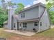 Spacious backyard featuring a two-story home with gray siding, a patio, and an outdoor grill at 445 Royal St, Mcdonough, GA 30253
