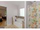 Bright bathroom features a soaking tub, neutral tile accents, and floral shower curtain at 445 Royal St, Mcdonough, GA 30253