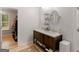 Bright bathroom features a double sink vanity, two round mirrors, and access to the walk-in closet at 445 Royal St, Mcdonough, GA 30253