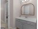 Bathroom featuring gray cabinets, a sink with an oval mirror, and neutral paint at 445 Royal St, Mcdonough, GA 30253